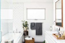 22 a Scandinavian bathroom with white and grey tiles, a basket for storage and potted plants