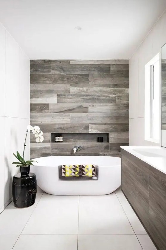 a contemporary bathroom with weathered wood touches and negative space for a comfy feel