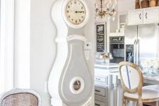 22 a shabby farmhouse kitchen and dining space with a grandfather’s clock in grey and white that matches the style of the space perfectly