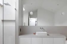 25 a white minimalist bathroom with an outdoor shower space, a sleek vanity with a sink and negative space for a light and airy feel