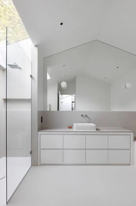 a white minimalist bathroom with an outdoor shower space, a sleek vanity with a sink and negative space for a light and airy feel