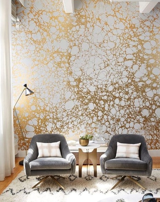 a printed gold and white wallpaper wall will make your living room very bold and stylish