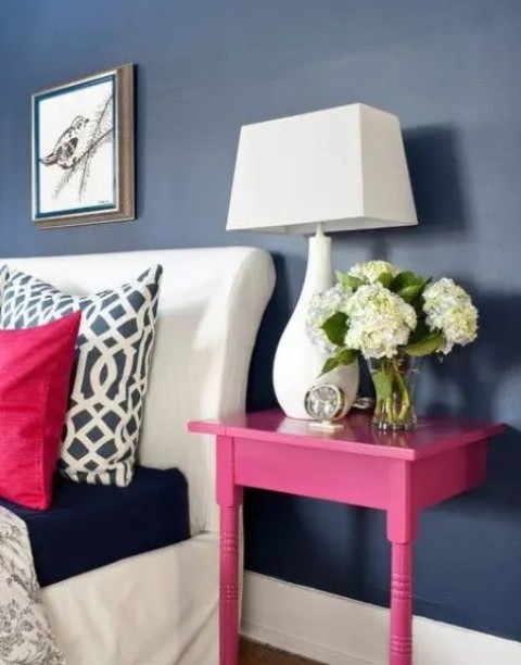 a nightstand made of a cut table and painted hot pink to make a perfect fit for the space, to add color and not to take much space
