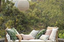 28 a rattan daybed with pastel and printed pillows, hanging woven pendant lamps and a side table is a lovely idea for outdoors