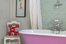 28 an eclectic bathroom with white walls and an aqua tile backsplash, a mauve clawfoot tub, a wooden mat and a shabby chic chair