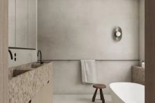 29 a wabi-sabi bathroom with limewashed walls, a neutral vanity with tan terrazzo sinks and some negative space for an airy feel