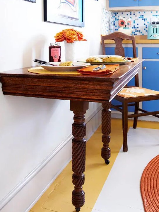 a wooden half table with casters is a great idea for a small eat-in kitchen like this one, it can be used for a breakfast nook, too