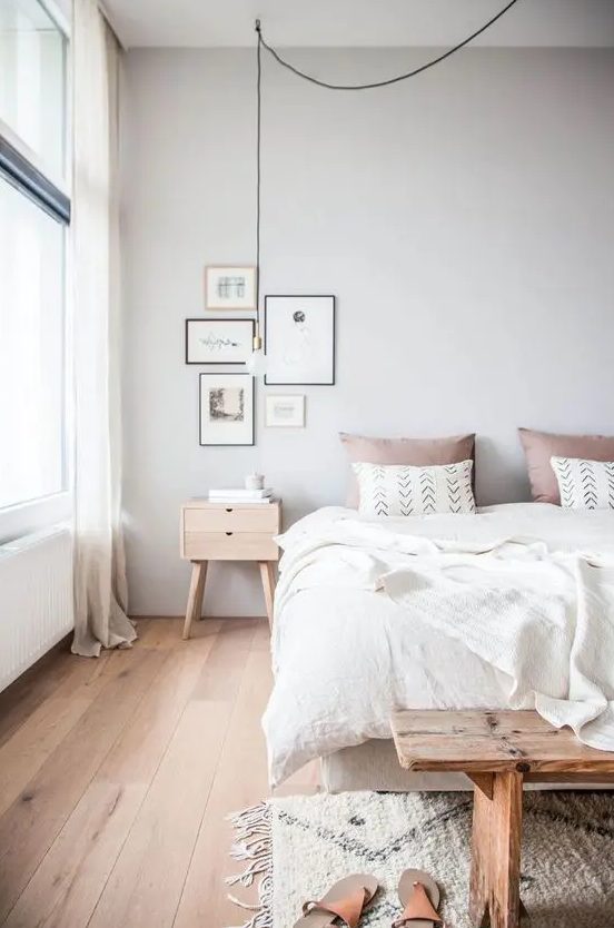 a welcoming and airy Scandinavian bedroom with all-natural linens and a touch of dusty pink
