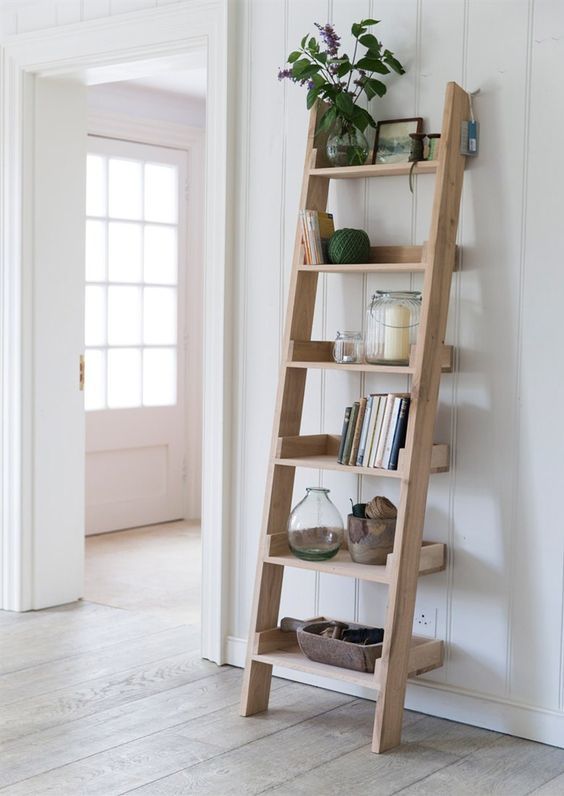 a leaning wall shelf   a ladder for storage is a brialliant idea for a rustic or farmhouse home