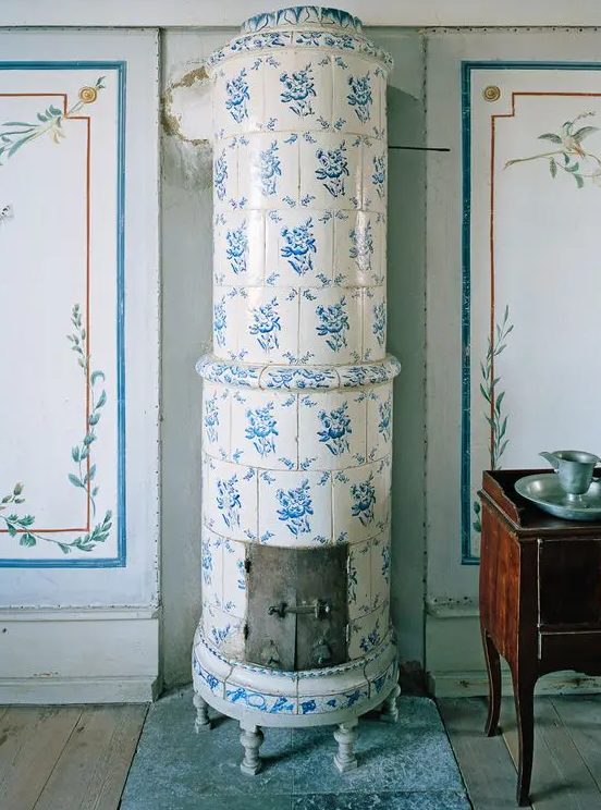 a traditional Scandinavian stove clad with blue and white printed tiles is a beautiful idea for a Nordic space, it will add both color and pattern
