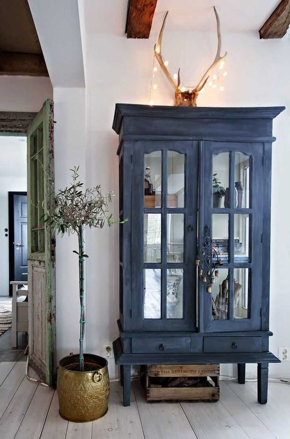 a beautiful navy chalkboard cupboard with elegant glass doors and sides, with drawers is a stylish way to add color and storage space