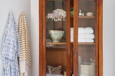 a beautiful vintage stained cabinet with glass doors is always a good idea, it can be used in any space to store and display your stuff