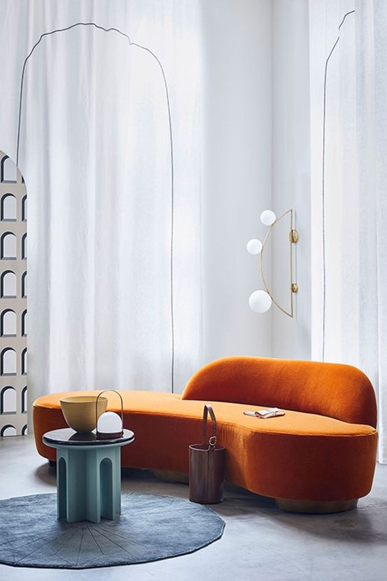 a lovely curved orange sofa for a modern living room