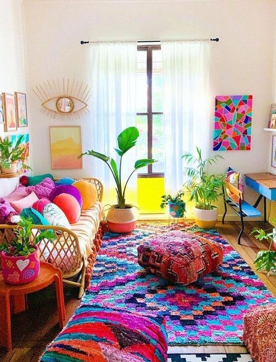 a bold maximalist living room with rattan and wooden furniture, colorful pillows, textiles and ottomans, potted plants