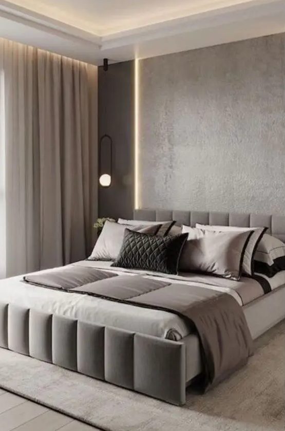 a clean contemporary bedroom with grey walls, built in lights on the ceiling, a large upholstered bed and neutral textiles is a lovely space