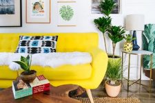 a colorful living room with a neon yellow sofa, a bright gallery wlal, potted plants and a wood slice coffee table