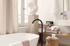 a contemporary bathroom with stone and wood, touches of blush and dusty pink for a girlish feel