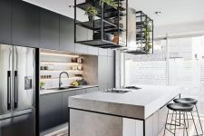 a contemporary kitchen with sleek black cabinets, a concrete kitchen island, black framing, black stools and built-in lights