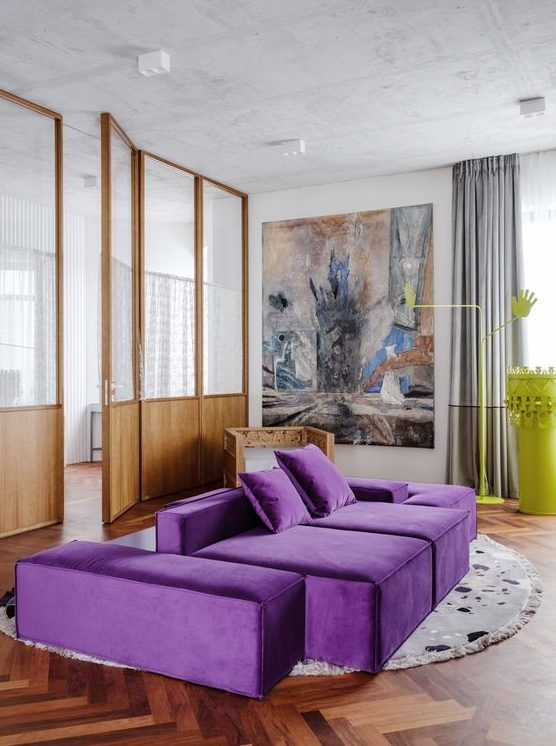 a contemporary living room with a neutral base, a bold purple sofa, a statement artwork, grey curtains and a neon yellow table