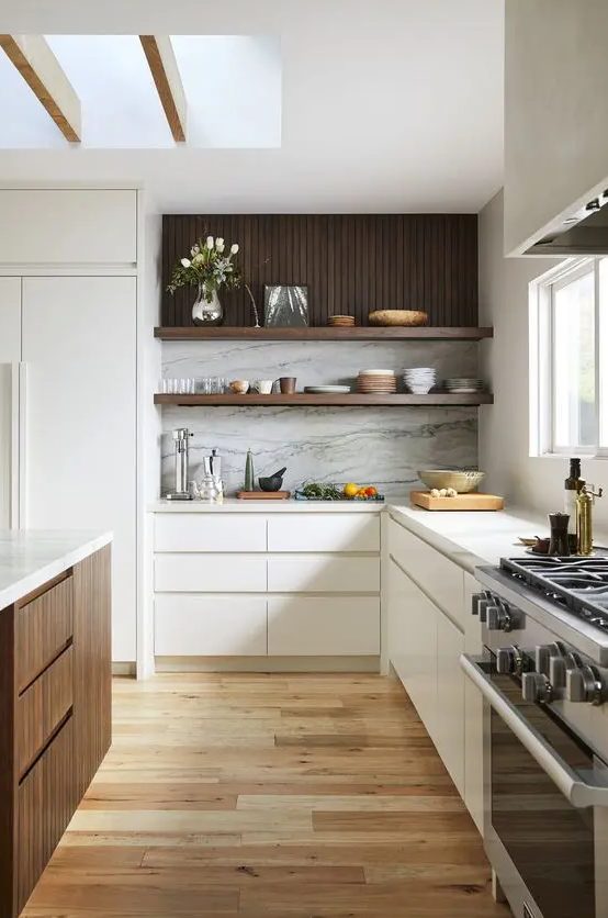 a cozy contemporary kitchen with sleek white and dark stained cabinets, a white stone backsplash and white countertops