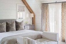 a creamy tufted bench at the foot of the bed is a stylish idea for a neutral sleeping space