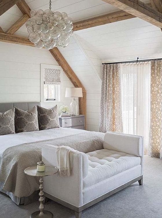 a creamy tufted bench at the foot of the bed is a stylish idea for a neutral sleeping space