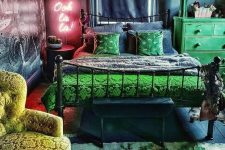 a dark maximalist bedroom with navy and grey walls, a forged bed, a green dresser, a neon light, statement artworks and a bold floral rug