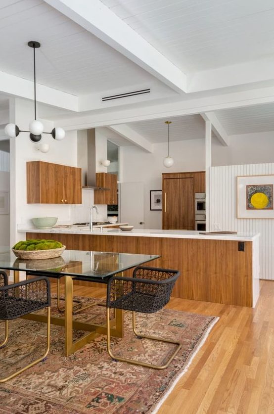 a large mid-century modern kitchen with wooden cabinets, white backsplashes and countertops