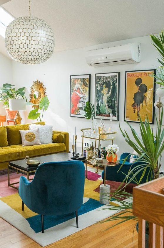 a maximalist living room with a mustard sofa, teal chairs, a colorful rug and a bold gallery wall plus potted plants