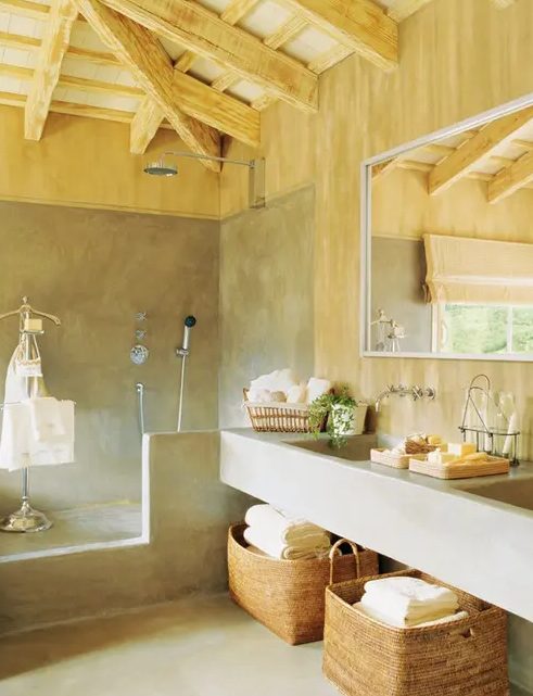 a modern farmhouse bathroom done in concrete and light-colored wood is a very cozy and welcoming space