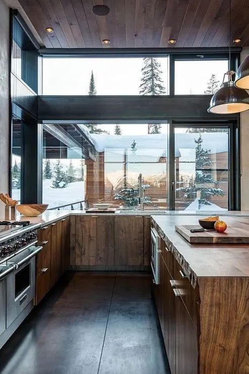 a modern rustic kitchen with stained wooden cabinets, ceiling and floor is a fine example of the style
