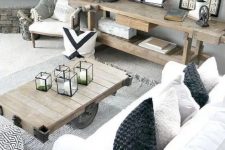 a neutral rustic modern farmhouse living room with touches of industrial style and wood slices, with rough wooden furniture