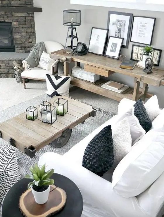 a neutral rustic modern farmhouse living room with touches of industrial style and wood slices, with rough wooden furniture