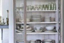 a shabby chic cupboard with white shelves and glass doors is a lovely idea for a shabby chic or Scandinavian space, for a kitchen or a dining room