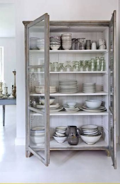 a shabby chic cupboard with white shelves and glass doors is a lovely idea for a shabby chic or Scandinavian space, for a kitchen or a dining room