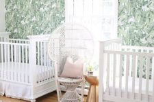 a lovely nursery design with a tropical wallpaper