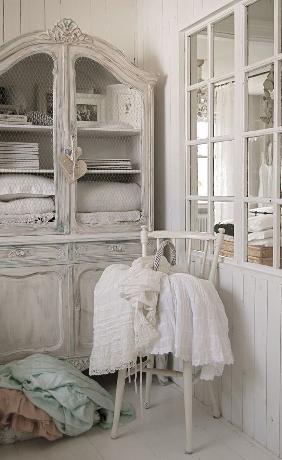 a white shabby chic cupboard with chicken wire doors and usual storage compartments is a stylish idea for a shabby chic space