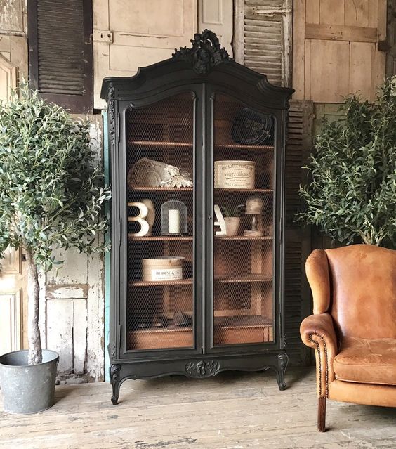 add elegance to your interior with a black vintage armoire but not with glass but with chicken wire doors
