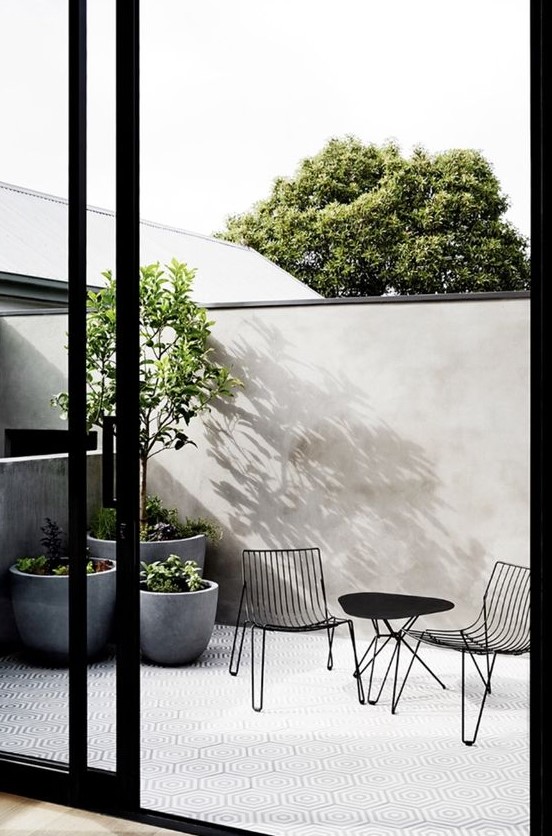 grey concrete cup like planters are very chic and very modern, they will fit many outdoor spaces