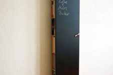 04 a tall and thin chalkboard storage unit hiding books, magazines and a wi-fi router can double as a note board or an art one