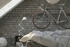 07 a holder for the bike attached to the wall over the bed gives the space a bold dynamic feel and matches the industrial interior