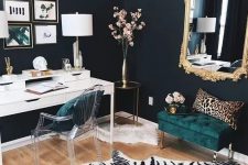 09 a refined working space with black walls, a white desk, an acrylic chairs, a dark green upholstered ottoman, a mirror in a gilded frame, a zebra print rug and a leopard print pillow