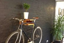 12 a simple and colorful shelf for holding a bike, with potted greenery is a cool idea to store your bike anywhere you want