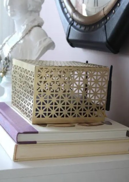 a laser cut metal box is a lovely idea to hide your wi fi router and it looks nice, so it won't spoil your interior
