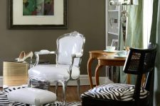 13 taupe walls, a vintage white chair and a zebra print one, a vintage table, a zebra print rug and a white footrest for a bold look