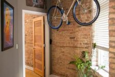 14 a special holder attached to the ceiling and holding a bike is a great idea for any space and it can be placed absolutely anywhere, not only in the corridor