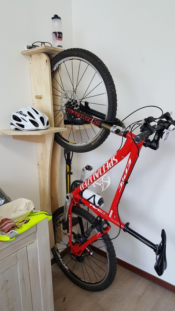a wall-mounted plywood shelf is a smart idea to store a bike and all the necessary stuff is an idea to apply everywhere you want