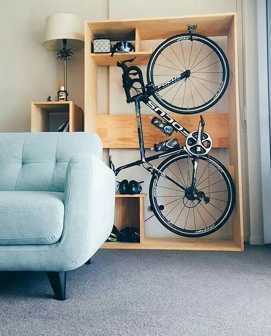 an open plywood storage unit with a bike and various stuff stored is a cool idea for a modern space and this unit can be placed even in a living room