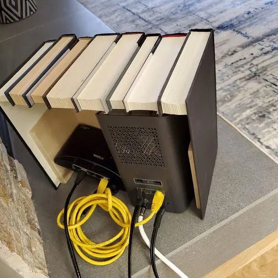 a box featuring fake books is a lovely space to hide any router or other electronics and looks very stylish