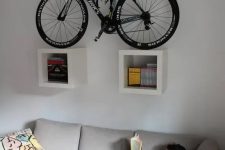 26 two box shelves attached to the wall and holding a bike can be a nice solution for a contemporary space and you may attached them anywhere, not only in an entryway